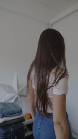 woman getting ready in a messy bedroom