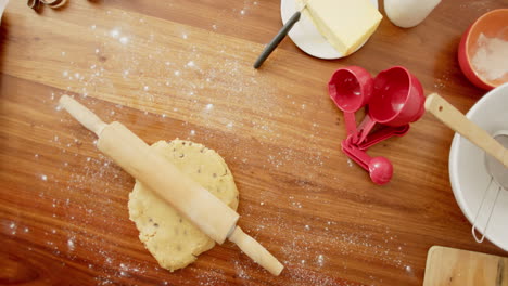 Baking-utensils-with-cookies-dough-lying-on-countertop-in-kitchen-at-home,-slow-motion