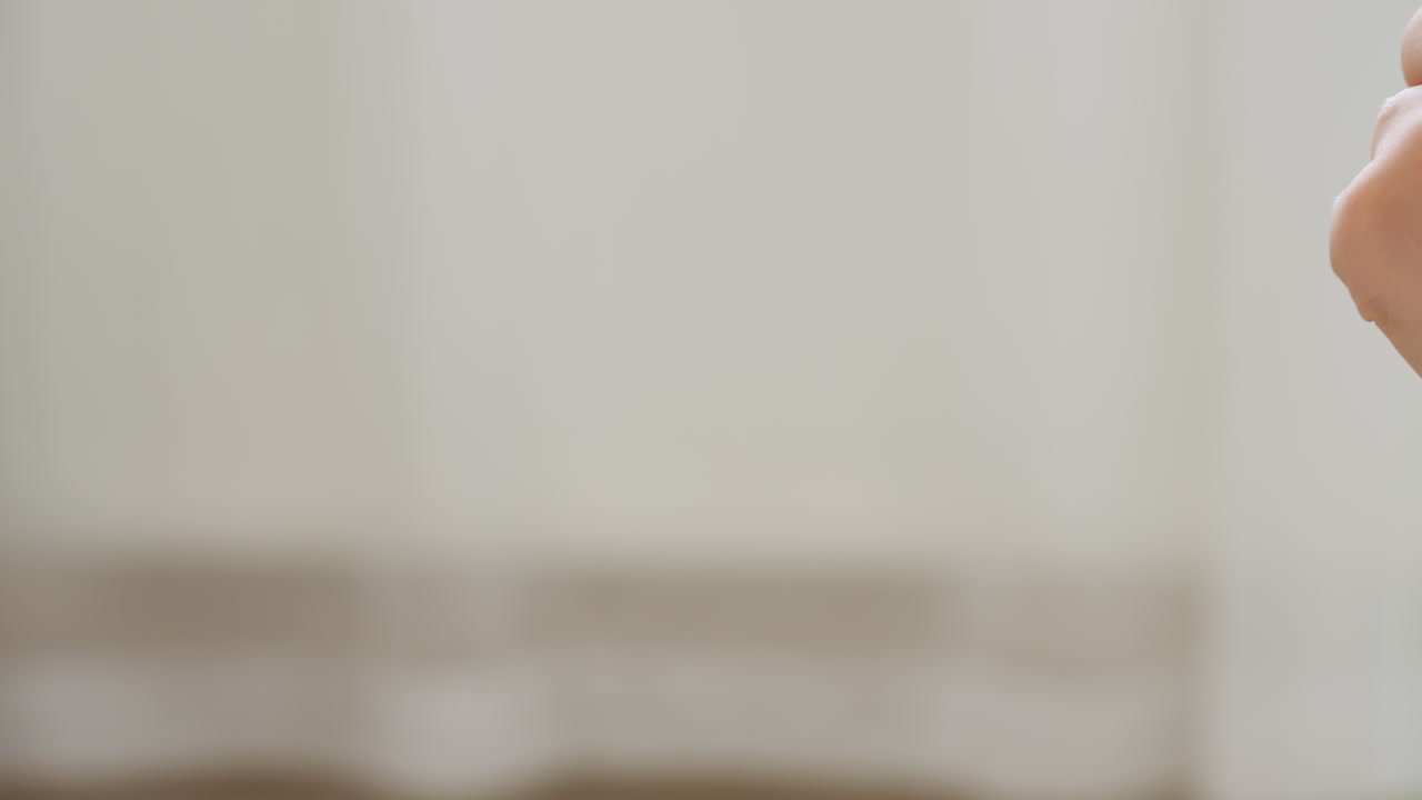 Close up of two blurred hands in fast motion while playing hand game indoors, emphasizing energy and movement during fun interaction in soft lit room with neutral background