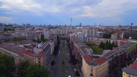 fabulous aerial top view flight city berlin suburban railroad station prefabricated building skyscrapers district neukoeln, germany summer day 2023