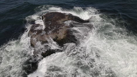 ocean-splashing-on-rocks-by-drone