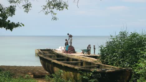 fishermen unloading nets on the coast of africa