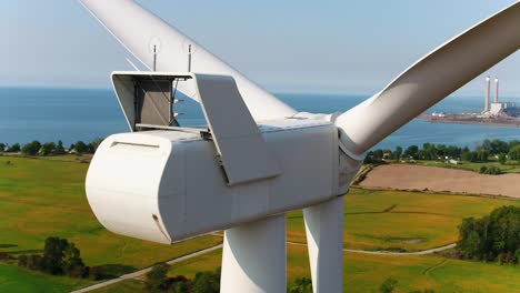 wind turbine nacelle with ocean and farmland background