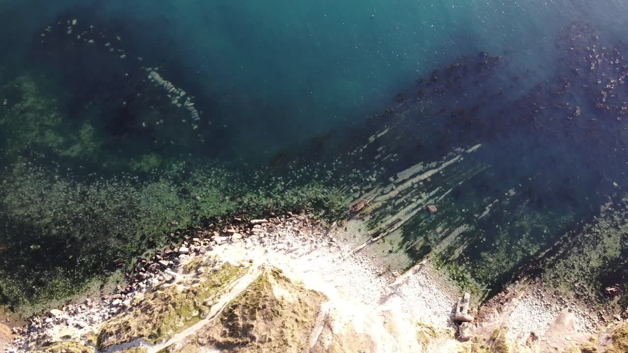 Aerial Top Down Look Across Chalk Coastline At Lulworth Cove In Dorset