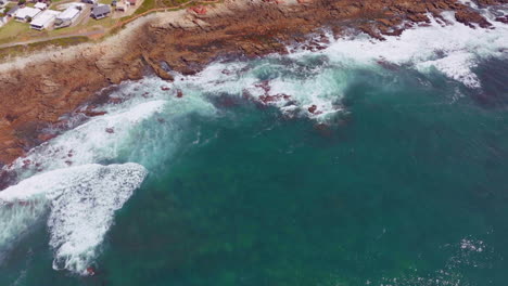 South-Africa-Still-Bay-Bae-beach-aerial-drone-cinematic-beach-small-surf-town-beach-reef-Garden-Route-Jeffreys-Bay-waves-crashing-aqua-blue-green-ocean-late-morning-afternoon-pan-down-forward-movement