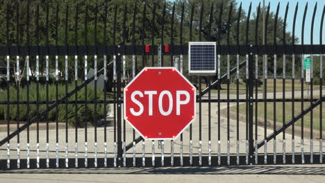 large solar powered flashing stop sign halts traffic at security gate -- 4k