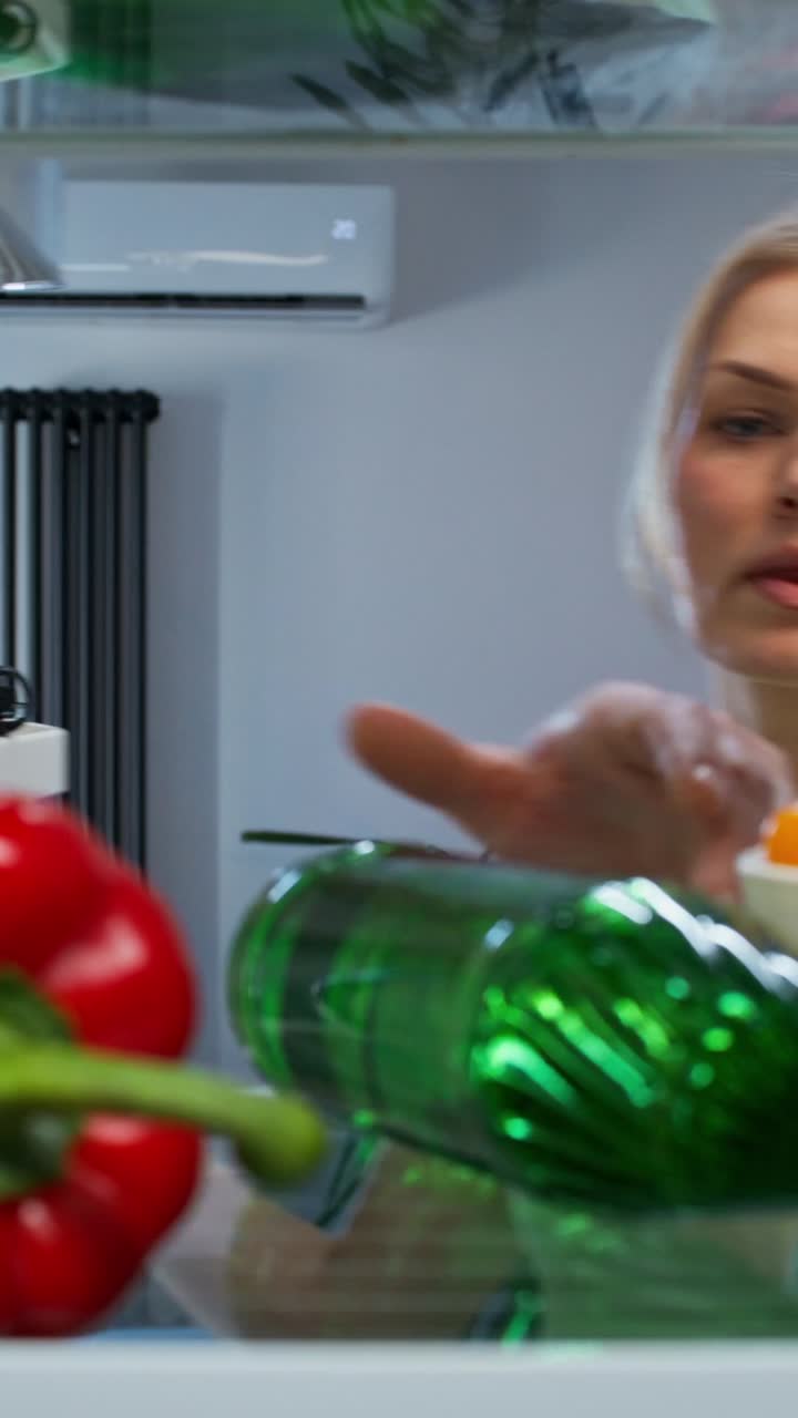 Woman inside a refrigerator looking for foods