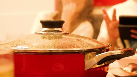 friends enjoying sukiyaki and shabu meal together