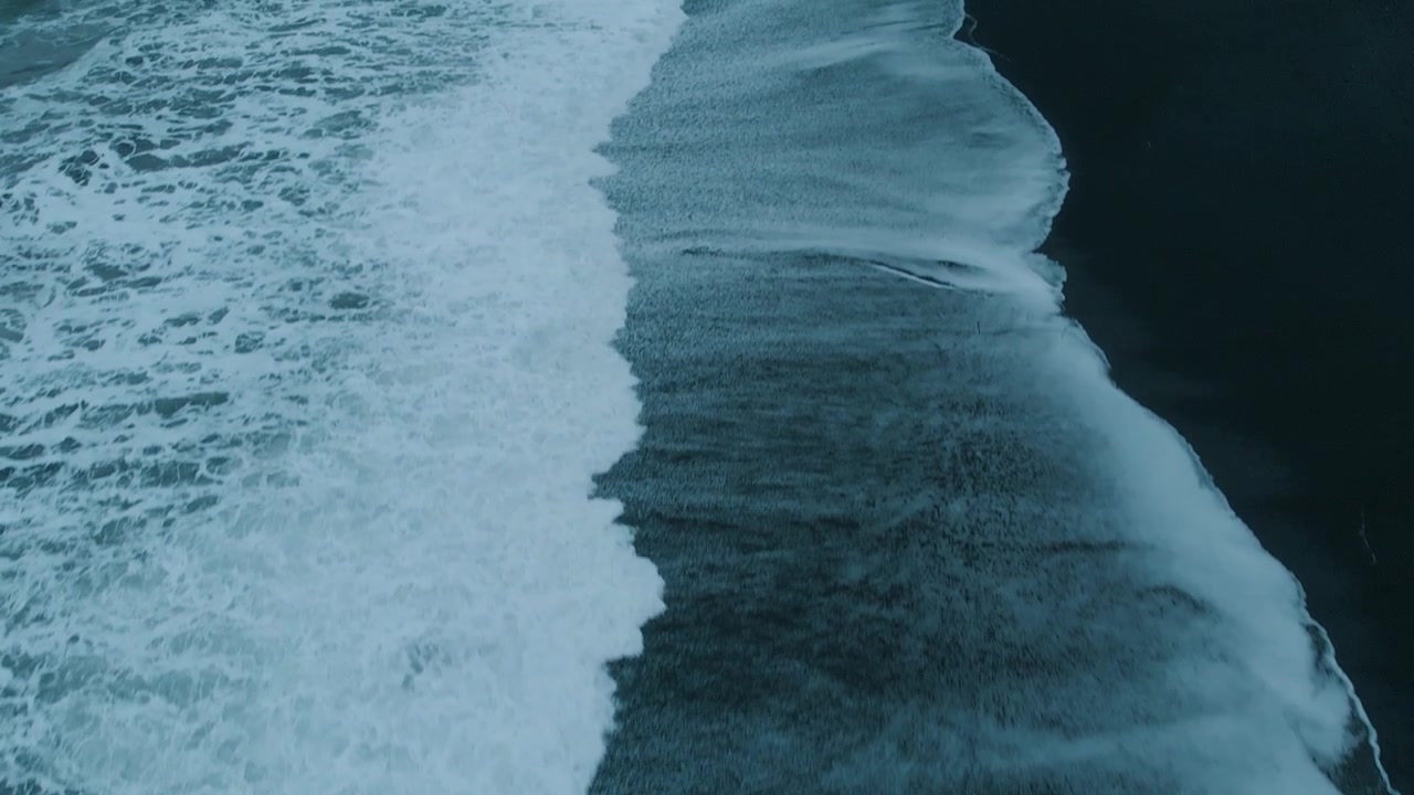 Aerial View of Powerful Ocean Waves on Black Sand Beach