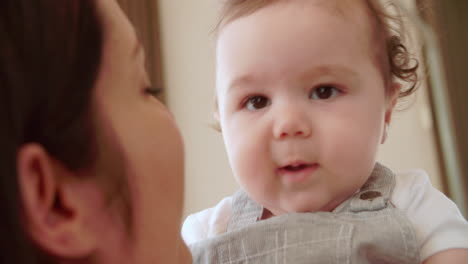 Mother-Playing-Game-With-Happy-Baby-Boy-On-Sofa-At-Home