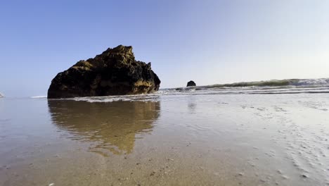 Rock-at-Malibus-beach-in-California,-waves-rolling-at-the-sea,-beautiful-landscape