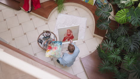 artist painting a woman in a red dress