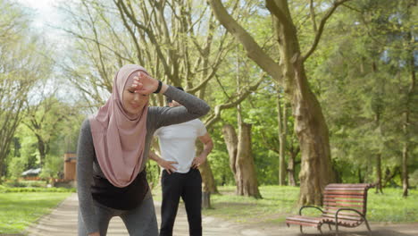 couple exercising in park