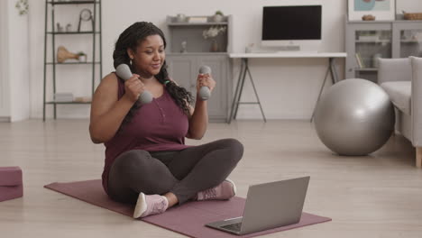 african woman having online workout