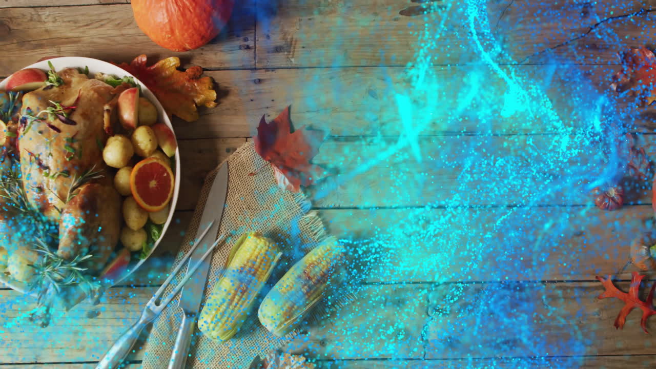 Thanksgiving meal with corn and leaves on wooden table, blue light animation overlay