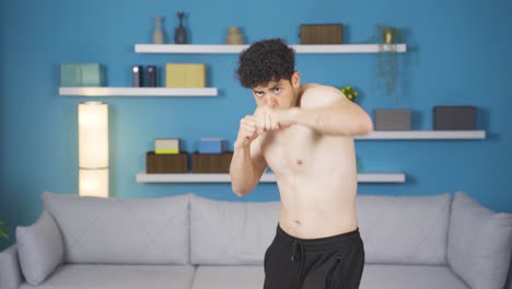 athlete young man exercising does shadow boxing. passion and perseverance.