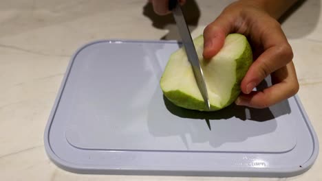 slicing a pear with a knife