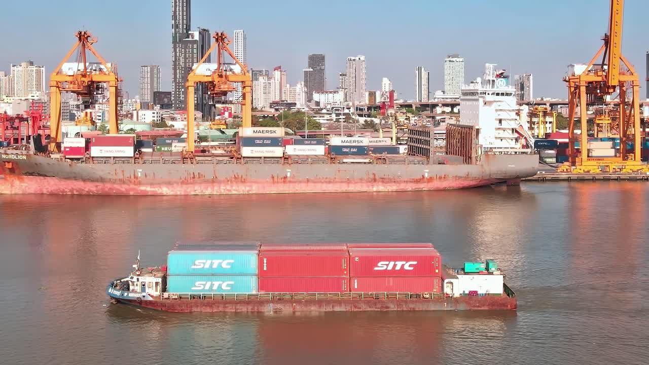 Busy Bangkok port with container ships and city skyline