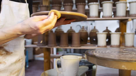 Close-Up-Of-Male-Potter-Putting-Glaze-Onto-Clay-Plaque-For-House-Sign-In-Ceramics-Studio