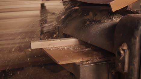 Lots-of-wood-chips-coming-out-from-the-grinding-machine.-The-rail-comes-out.-Close-up