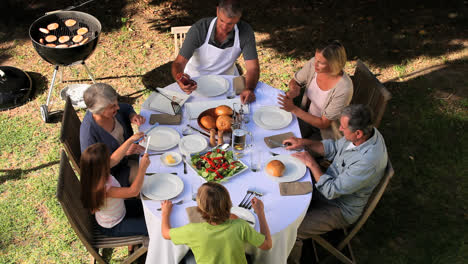 Family-sorting-out-cutlery-at-the-garden-table-before-eating