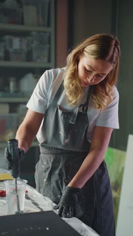woman artist working on resin art project