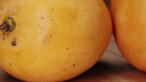 closeup of two yellow mangoes