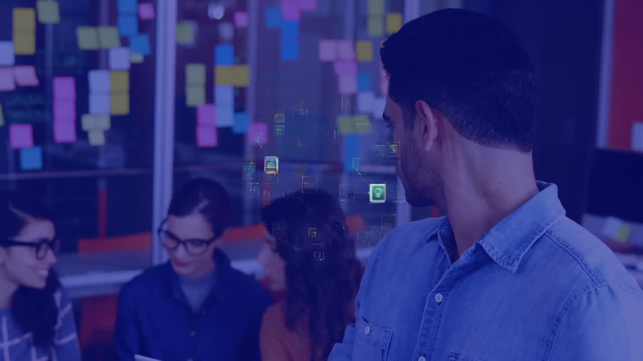 animación de iconos conectados formando un globo sobre un hombre biracial usando una tableta digital en la oficina.
