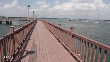 a wooden bridge along the sea