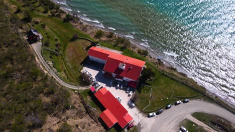 drone shot descending while tracking the hosteria kaiken on the shores of lago fagnano in tierra del fuego, argentina