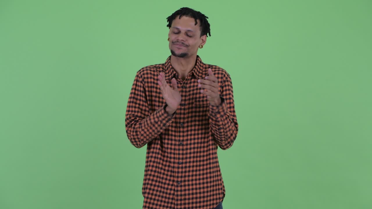 Happy young handsome African man with dreadlocks
