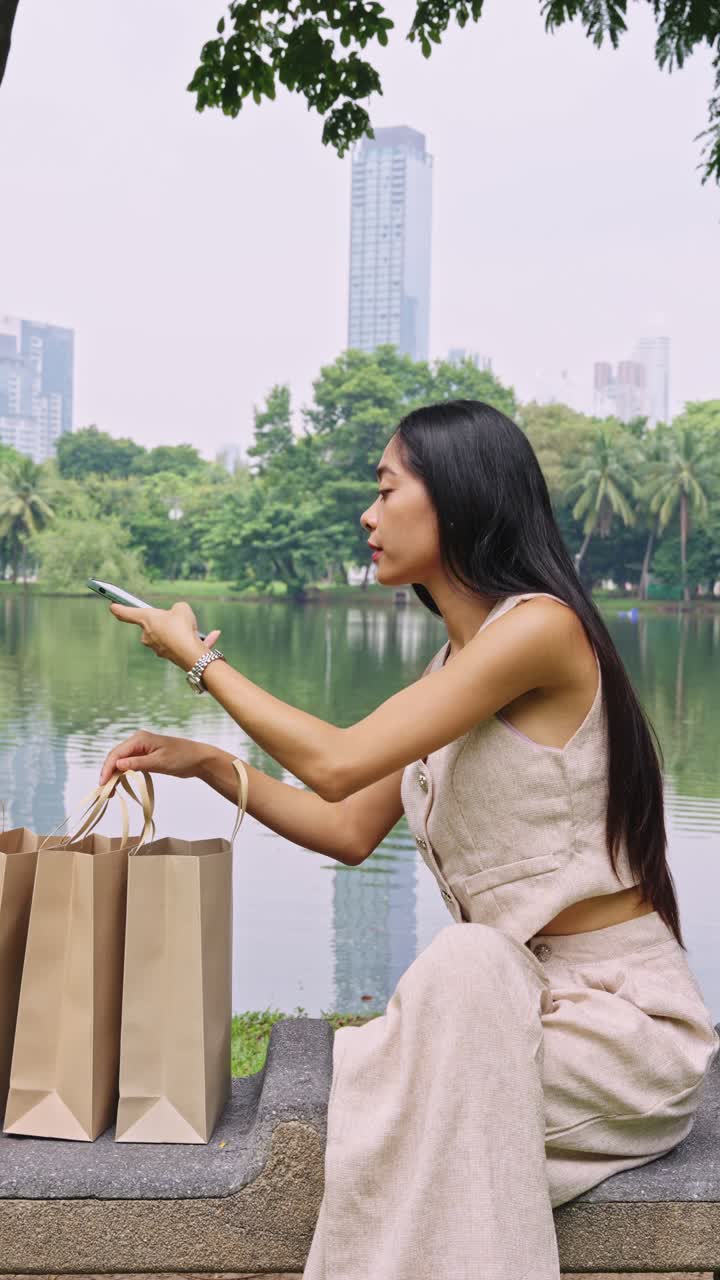 Woman with shopping bags in a park