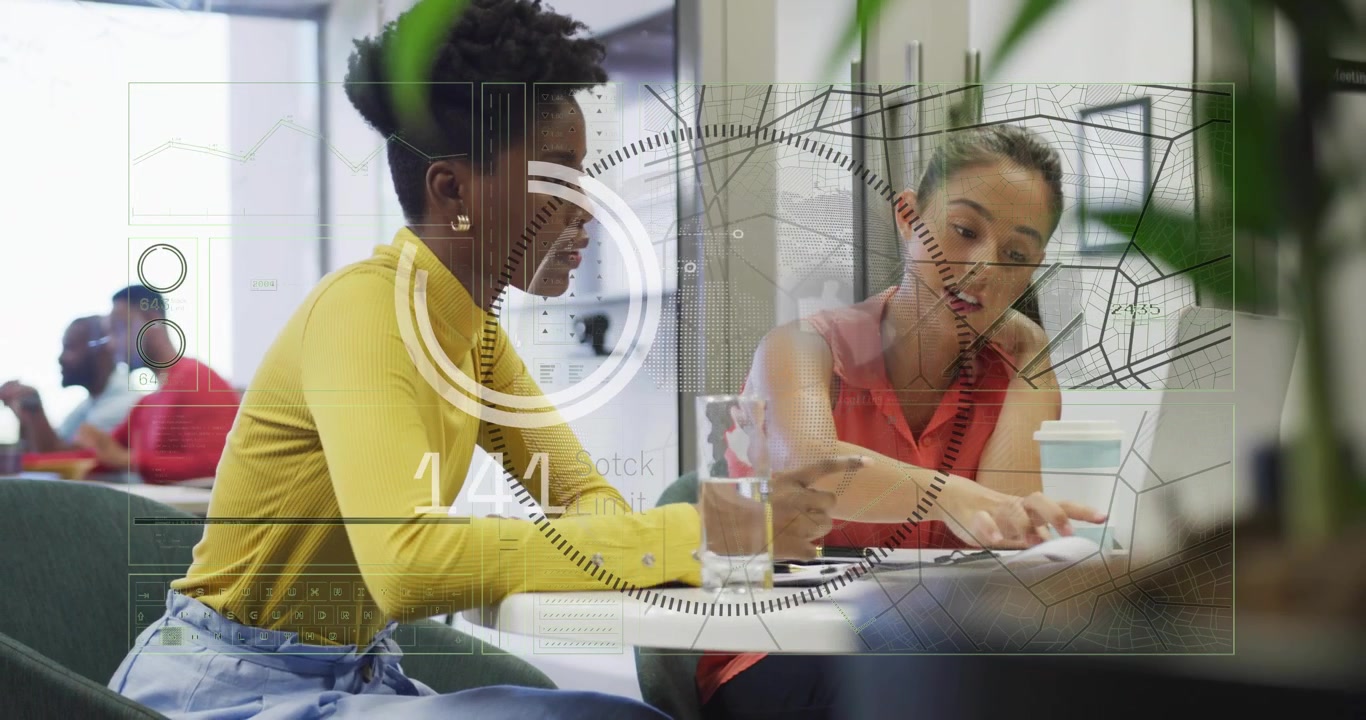 Working women wearing coral and yellow pointing at laptop and papers at office with HUD appearing