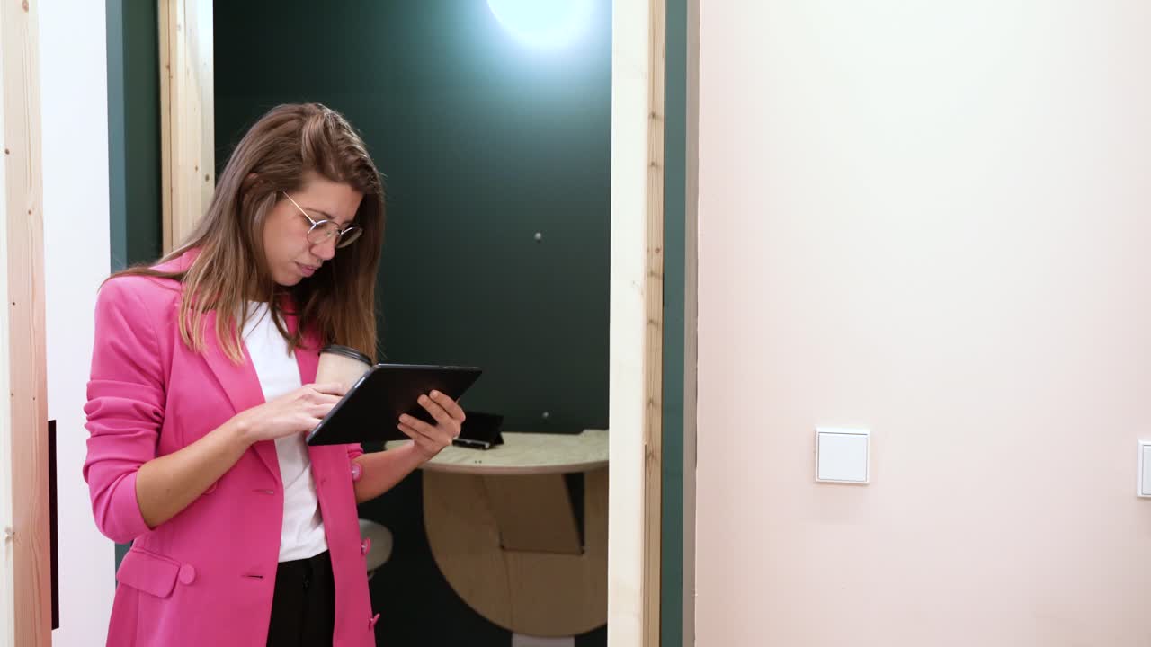 Woman browsing tablet in office