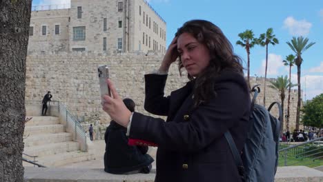 woman taking selfie at famous jerusalem landmark