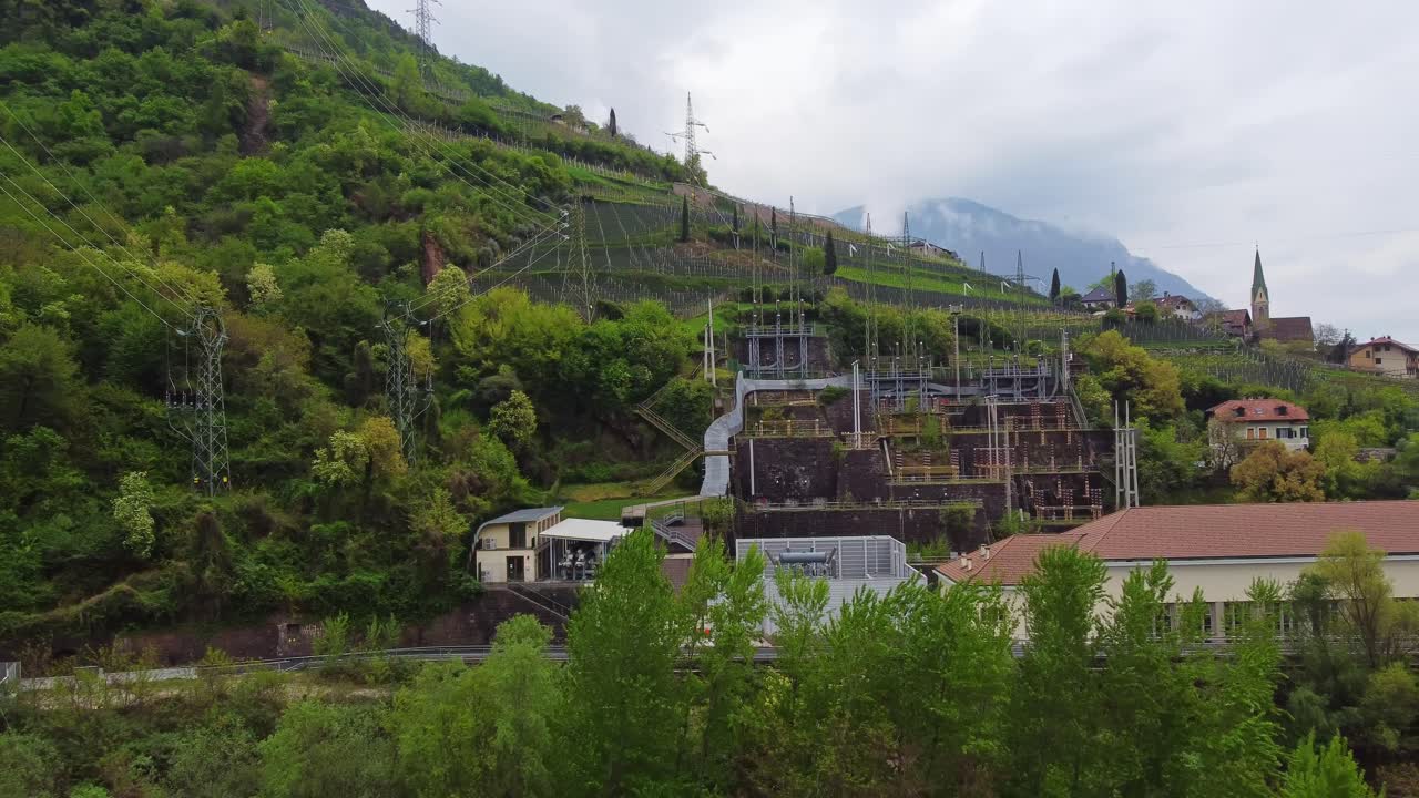 Electric power station in Bolzano on hill with vineyards, vital infrastructure in remote areas