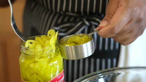 Measuring-out-pickled-pepperoncini-to-add-to-a-chopped-Italian-salad---ANTIPASTO-SALAD-SERIES