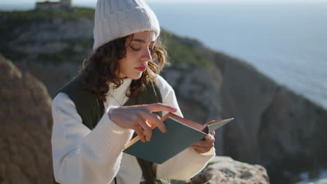 Smiling-woman-enjoying-literature-at-beautiful-ocean-vertical.-Calm-sea-morning