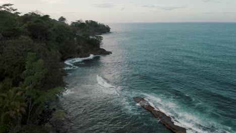 turquoise blue waves crashing on rocky outcrops near the island of punta mona, caribbean coast of costa rica