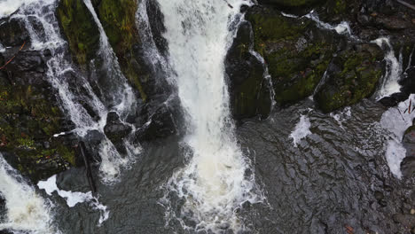 4k drone footage overhead of waterfall and river in forest