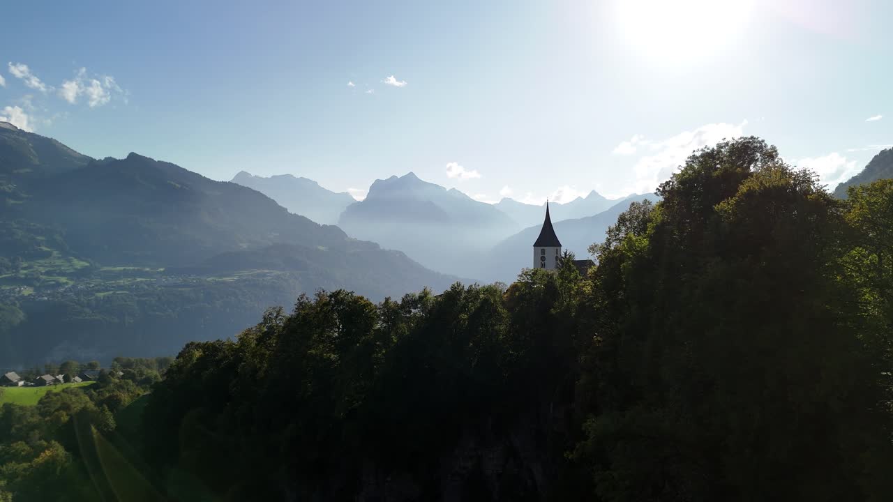 Switzerland church in nature forest landscape, mountains hills highlights