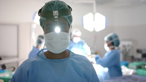 portrait of african american female surgeon wearing flashlight on head, slow motion