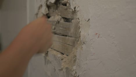 fists punching plastered wall. slow motion, close up