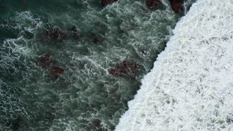 broken wave in bali indonesia washes across frame completely