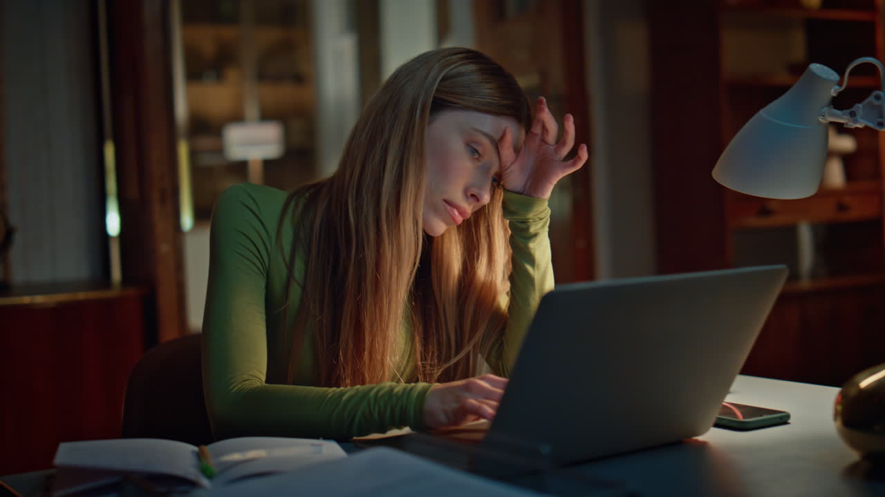 Tired manager working night home looking laptop close up. Woman writing copybook