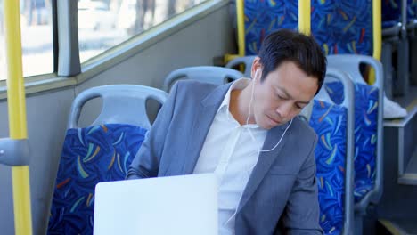 businessman inserting earphone jack in laptop 4k