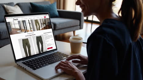 person browsing and shopping for cargo pants online on a laptop