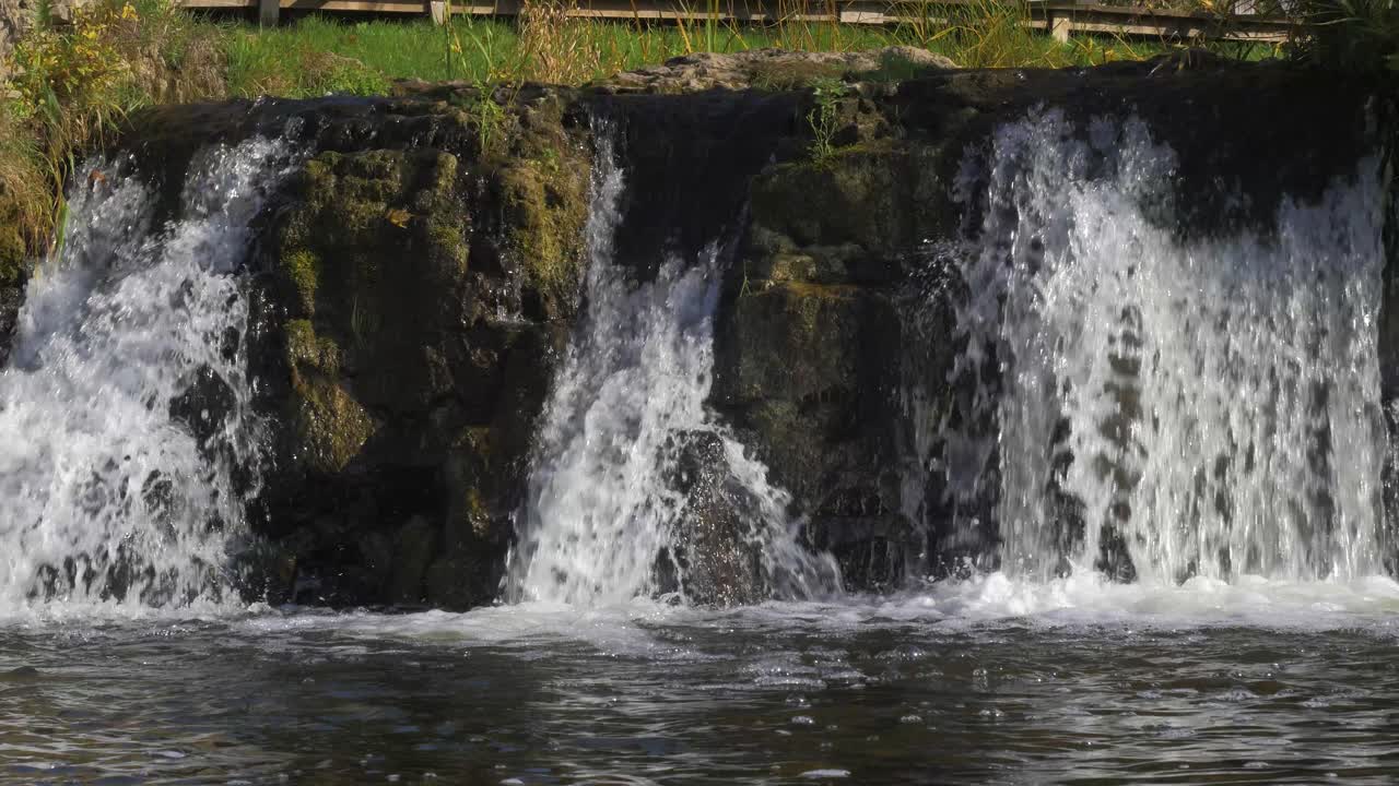 Venta river Rapid mid-shot, the widest waterfall in Europe in sunny autumn day, located in Kuldiga city, Latvia