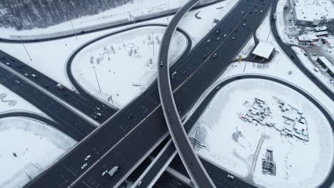 aerial view of a freeway intersection snow-covered in winter.