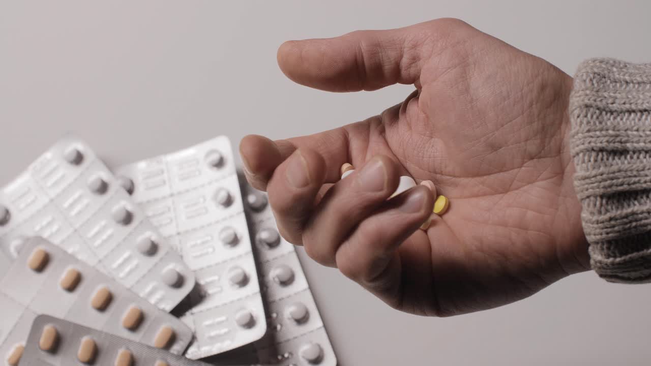 Different kinds pills in men's palm